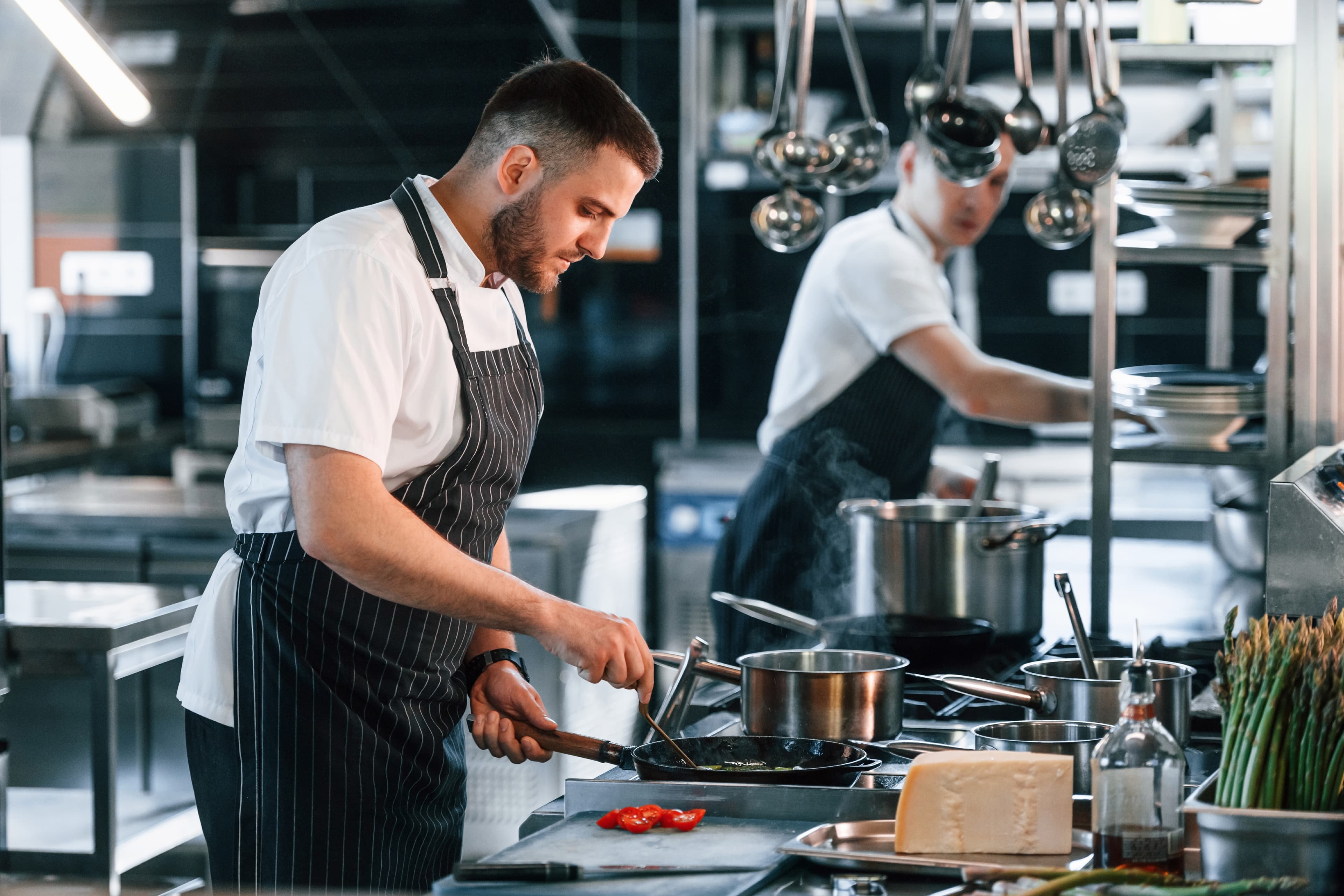 A team of chefs and kitchen staff smiling
